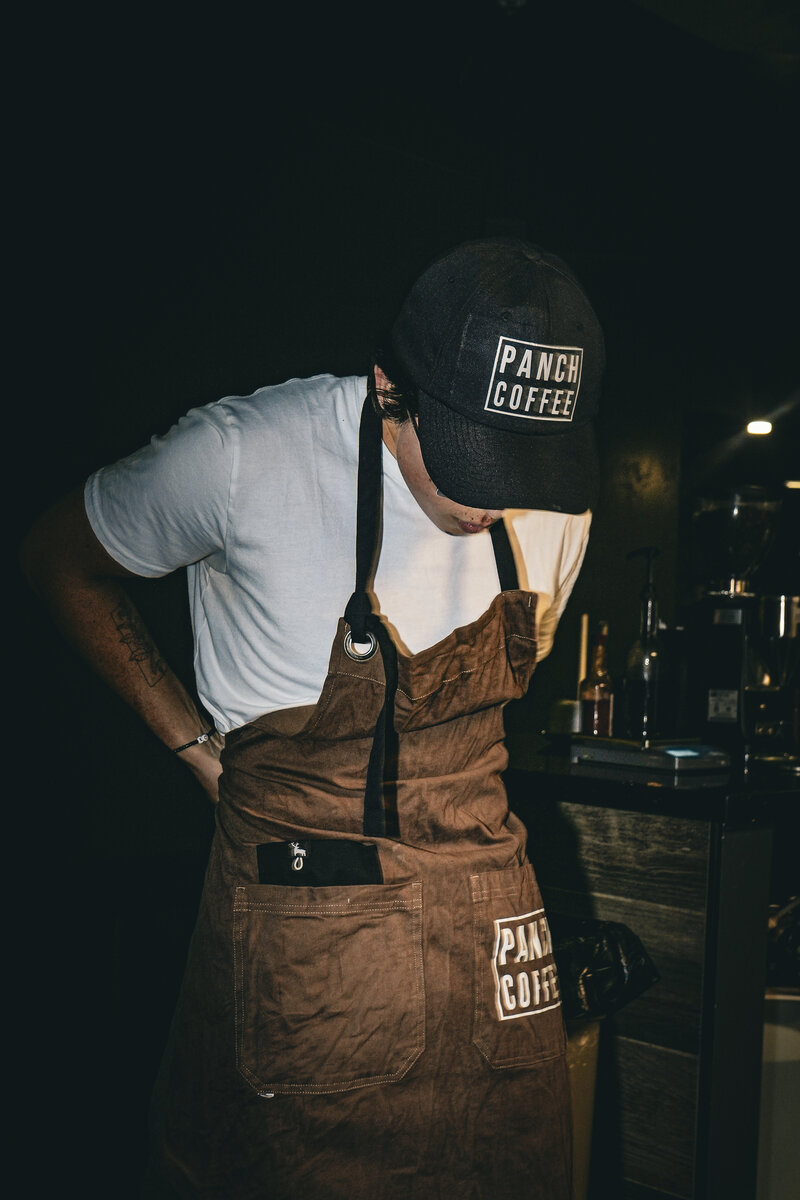 Barista in an apron at a local coffee shop